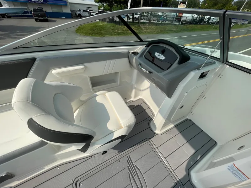 Slide: The Image of 2024 Chaparral 23 SSi OB boat interior with helm and seating. - 35