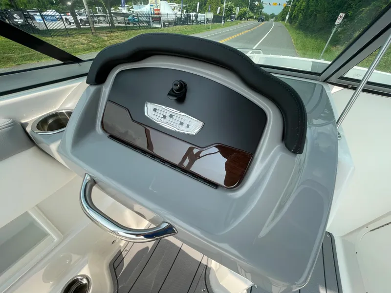 Slide: The Image of 2024 Chaparral 23 SSi OB boat dashboard with storage compartment. - 36