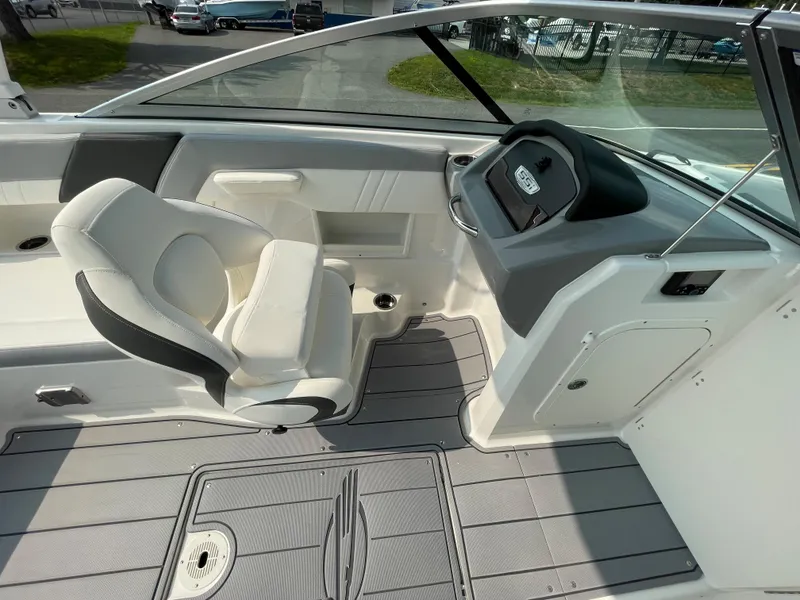 Slide: The Image of 2024 Chaparral 23 SSi OB boat interior with captain's chair and dashboard. - 39