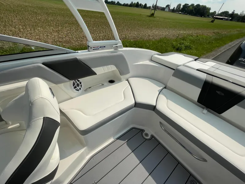 Slide: The Image of 2024 Chaparral 23 SSi OB boat interior with white and black seating. - 40
