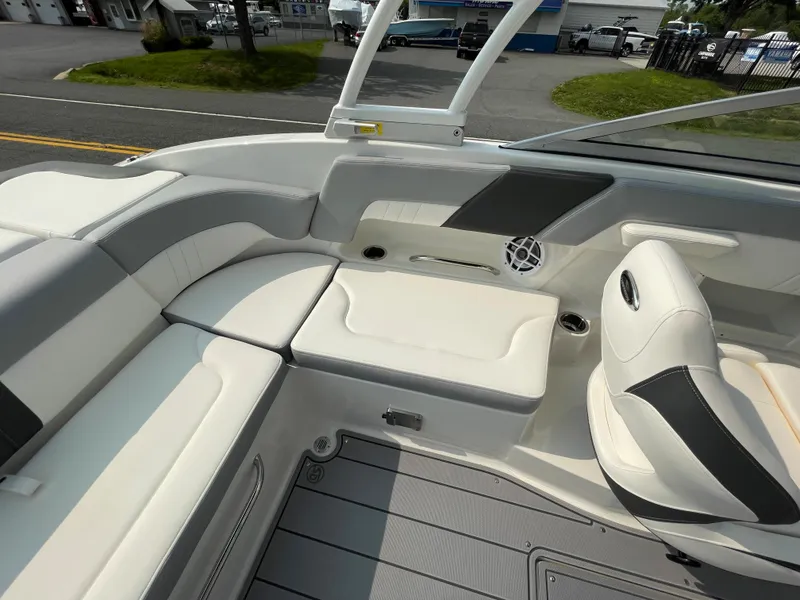Slide: The Image of 2024 Chaparral 23 SSi OB boat interior with white and gray seating. - 42