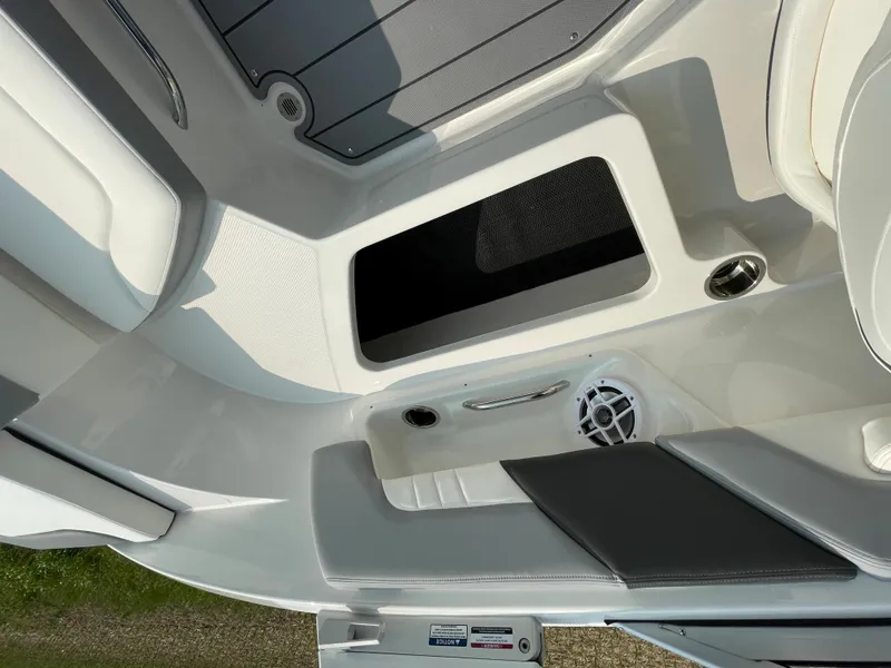 Slide: The Image of 2024 Chaparral 23 SSi OB boat interior with seating and storage compartments. - 44