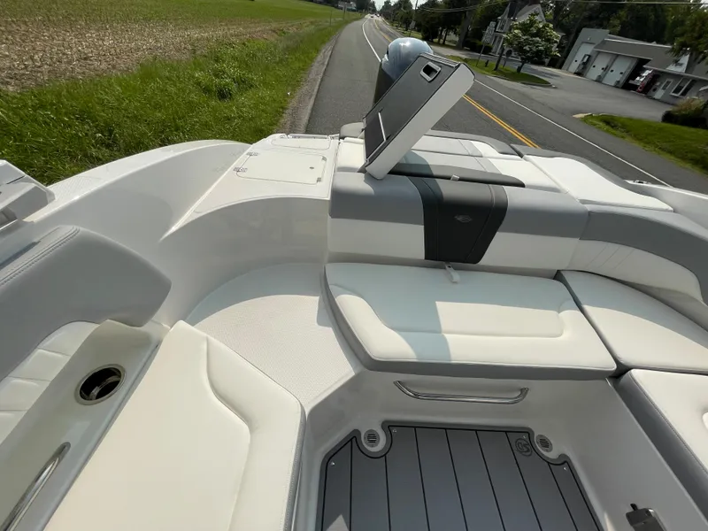 Slide: The Image of 2024 Chaparral 23 SSi OB boat interior with white and gray seating. - 45