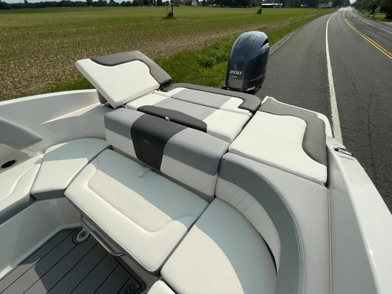 Slide: The Image of 2024 Chaparral 23 SSi OB boat with luxurious seating and outboard motor. - 46