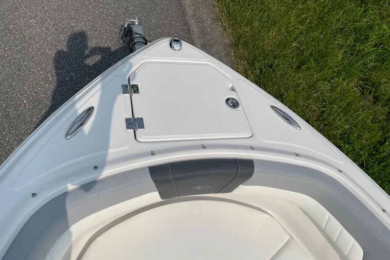 Slide: The Image of 2024 Chaparral 23 SSi OB boat bow with storage compartment. - 8