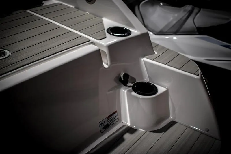 Slide: The Image of 2023 Yamaha Boats AR220 deck with cup holders and seating area. - 10