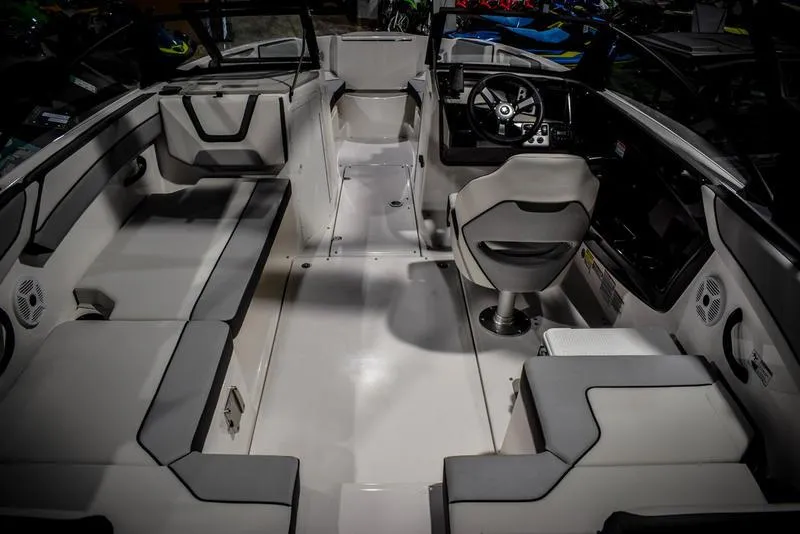 Slide: The Image of 2023 Yamaha Boats AR220 interior with seating and steering console. - 13