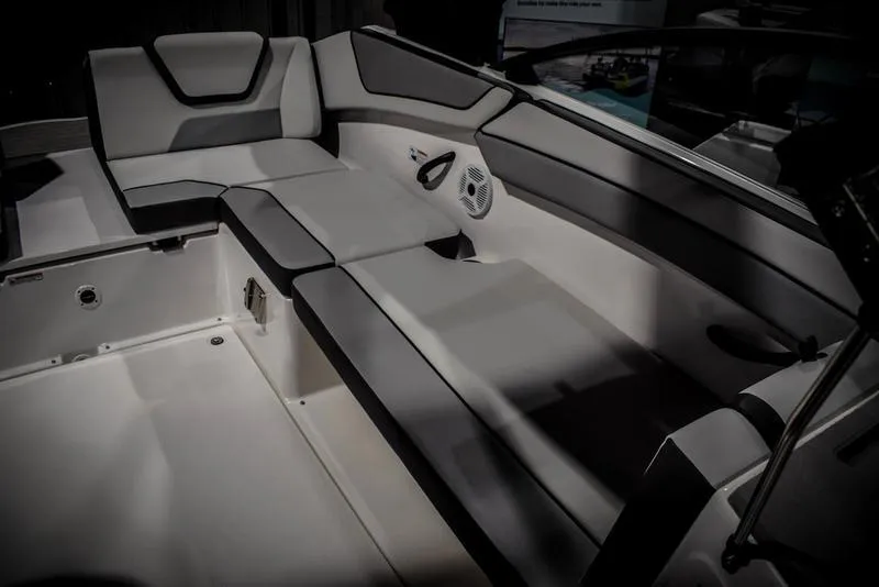 Slide: The Image of 2023 Yamaha Boats AR220 interior seating area with cushioned seats and speaker. - 15