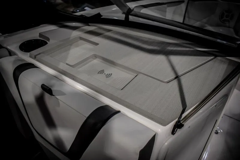 Slide: The Image of 2023 Yamaha Boats AR220 interior dashboard with wireless charging pad. - 21