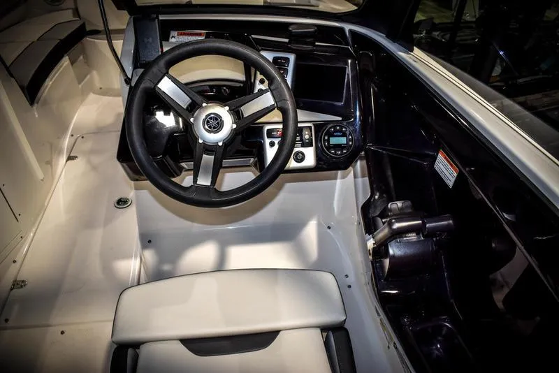 Slide: The Image of 2023 Yamaha Boats AR220 cockpit with steering wheel and control panel. - 22