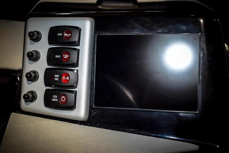 Slide: The Image of Control panel of 2023 Yamaha Boats AR220 with touchscreen and switches. - 25
