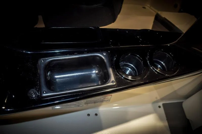 Slide: The Image of Yamaha Boats AR220 2023 model interior with cup holders and storage compartment. - 28