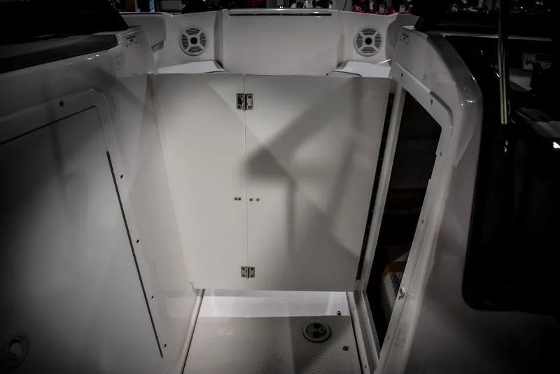 Slide: The Image of 2023 Yamaha Boats AR220 interior with storage compartment and speakers. - 33