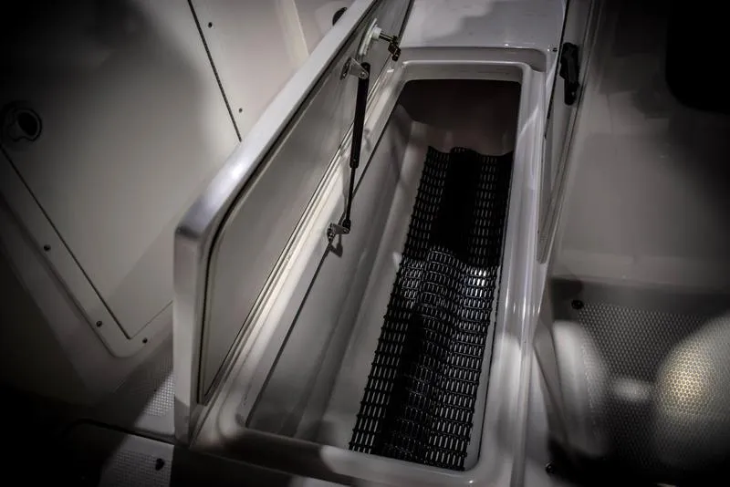 Slide: The Image of Open storage compartment in 2023 Yamaha Boats AR220. - 34