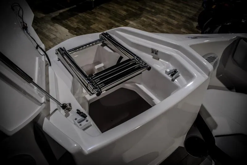 Slide: The Image of 2023 Yamaha Boats AR220 storage compartment with foldable ladder. - 38