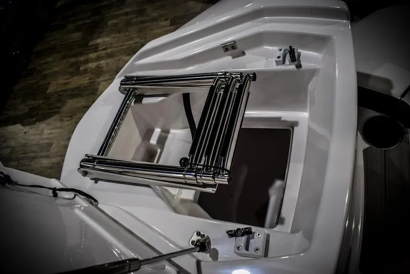 Slide: The Image of 2023 Yamaha Boats AR220 with open storage compartment and folded ladder. - 39