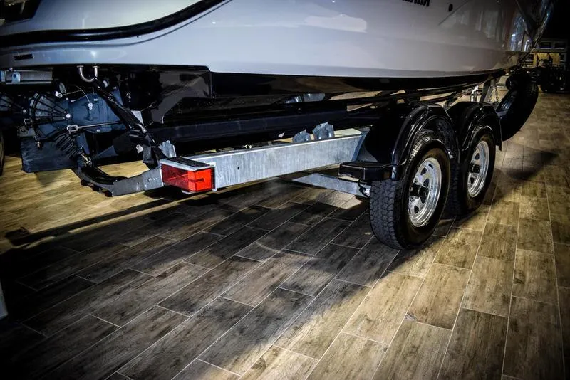 Slide: The Image of 2023 Yamaha Boats AR220 on a dual-axle trailer in a showroom. - 41