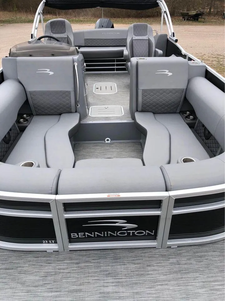 Slide: The Image of 2022 Bennington 24 RTSB pontoon boat with spacious gray seating and sleek design. - 1