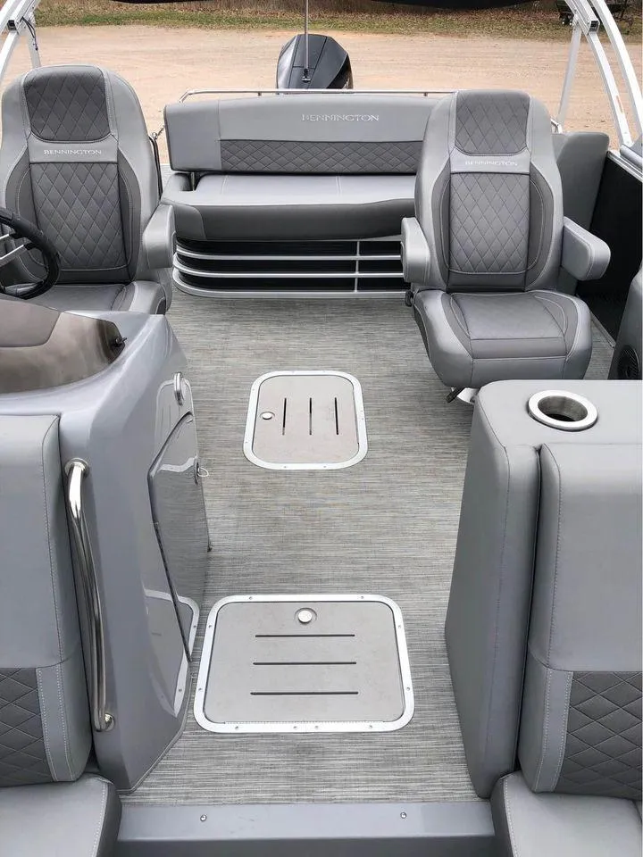 Slide: The Image of 2022 Bennington 24 RTSB pontoon boat interior with gray seating and flooring. - 2