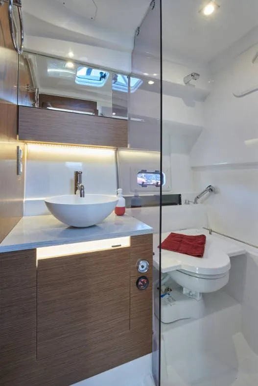 Slide: The Image of 2024 Jeanneau Leader 10.5 Walk Around bathroom with modern fixtures and wooden cabinetry. - 6