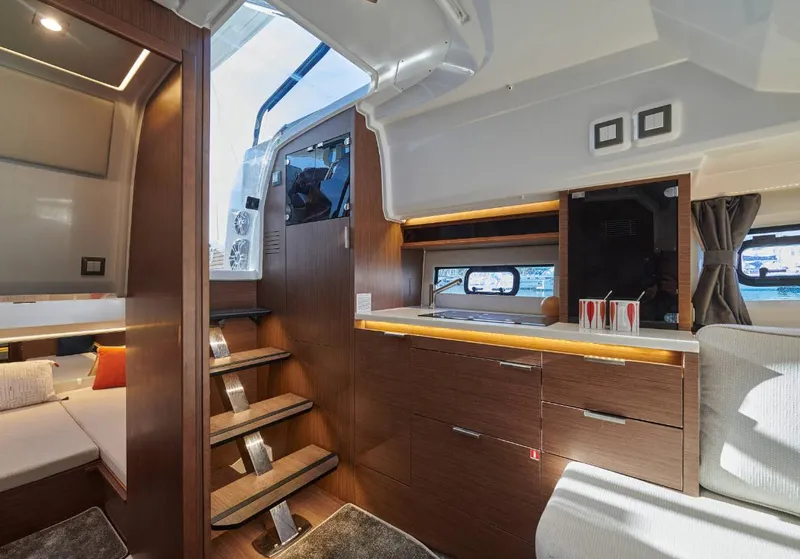 Slide: The Image of Interior of 2024 Jeanneau Leader 10.5 Walk Around boat with modern wood finish. - 7
