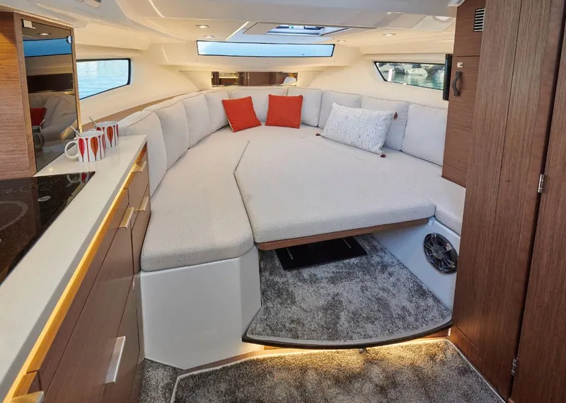 Slide: The Image of 2024 Jeanneau Leader 10.5 Walk Around interior cabin with modern design and cozy seating. - 8