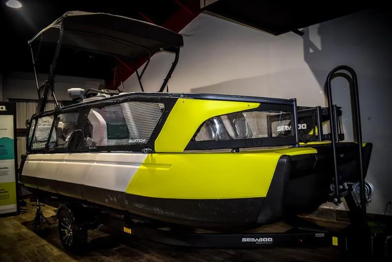 The Image of 2022 Sea-Doo Switch Sport 21, yellow and black, on trailer in indoor setting. - 1