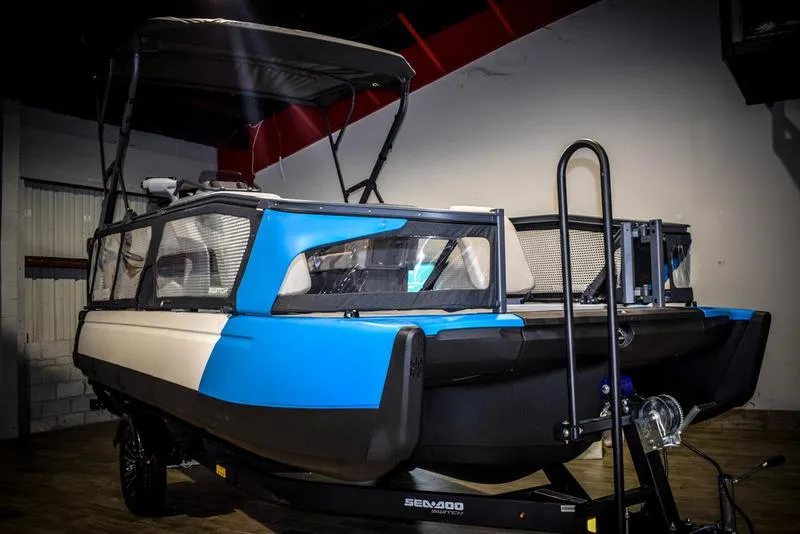 The Image of 2023 Sea-Doo Switch Sport 21 pontoon boat in a showroom. - 1