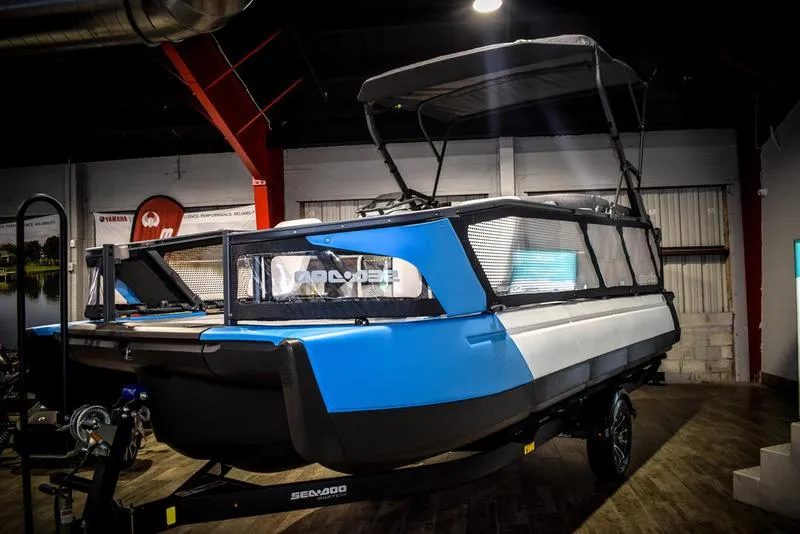 Slide: The Image of 2023 Sea-Doo Switch Sport 21 pontoon boat in showroom. - 3