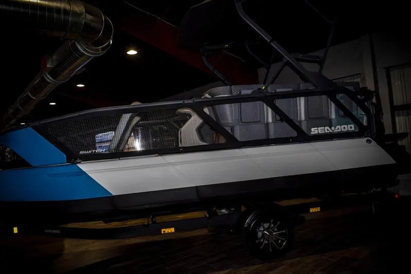 Slide: The Image of 2023 Sea-Doo Switch Sport 21 pontoon boat displayed indoors. - 4