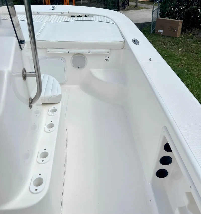 Slide: The Image of 2010 Carolina Skiff 198 DLV Elite boat interior with rod holders and seating. - 11