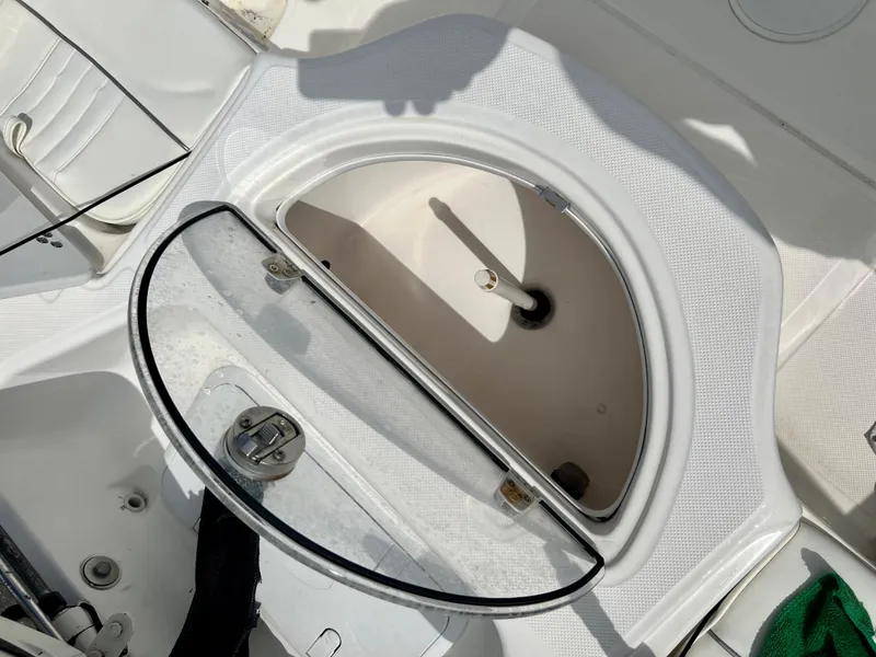 Slide: The Image of 2010 Carolina Skiff 198 DLV Elite boat storage compartment with open lid. - 12