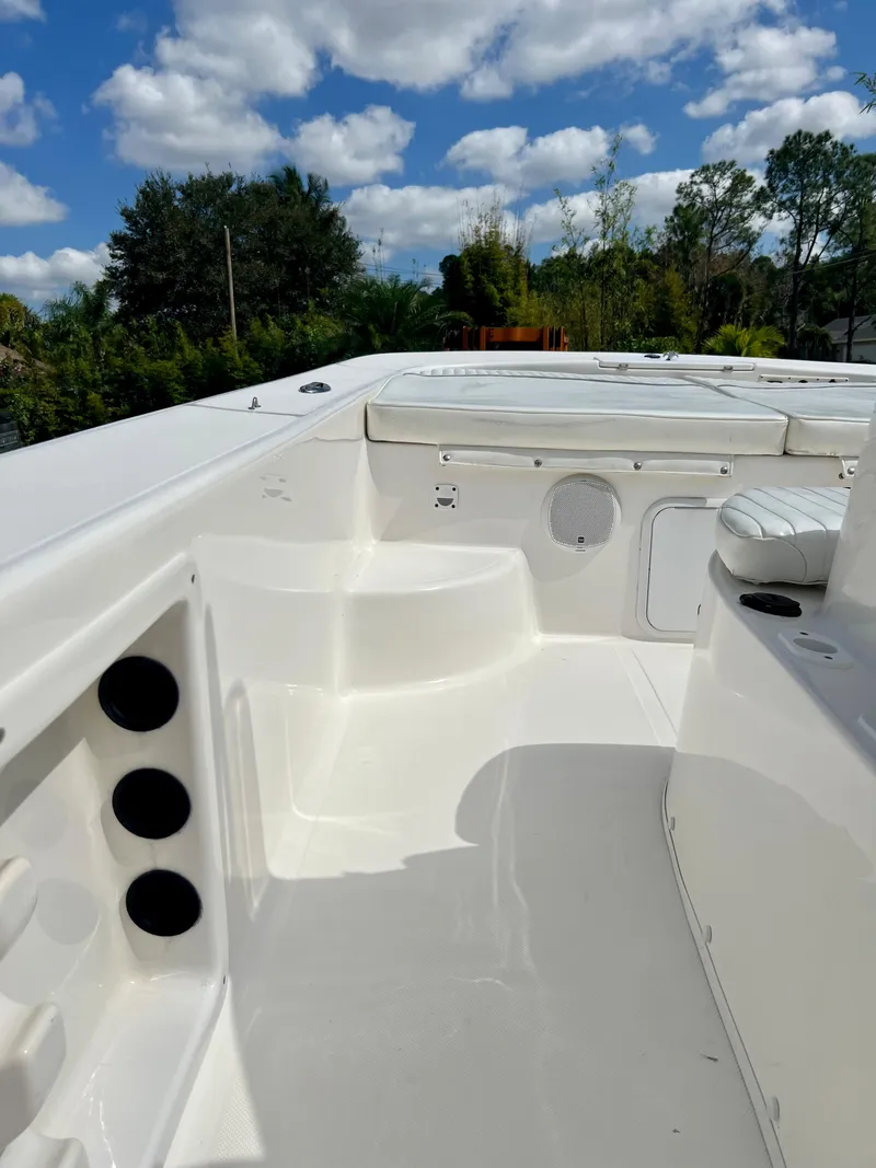 Slide: The Image of 2010 Carolina Skiff 198 DLV Elite boat interior with seating and storage compartments. - 14