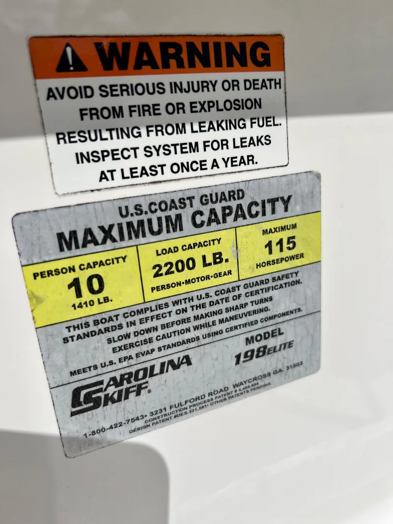 Slide: The Image of Warning and capacity labels on a 2010 Carolina Skiff 198 DLV Elite boat. - 15