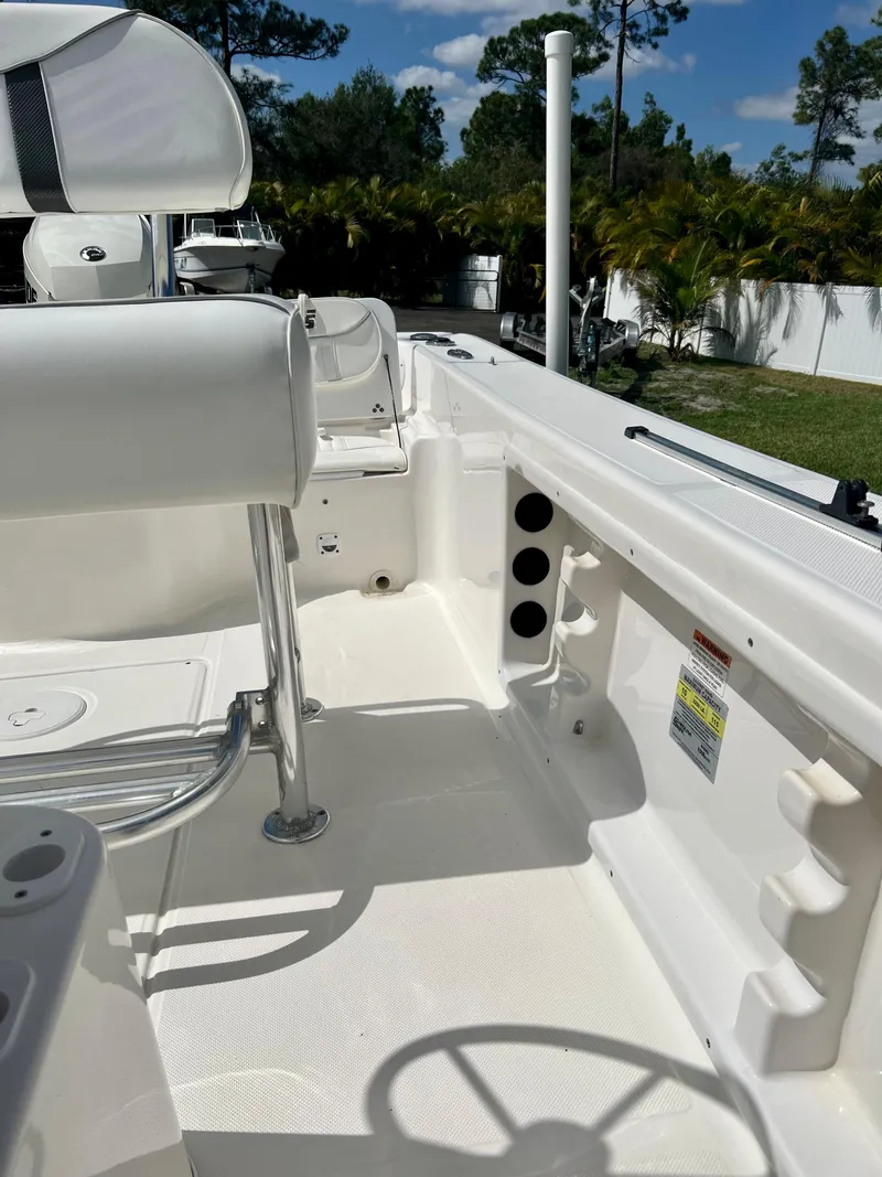 Slide: The Image of 2010 Carolina Skiff 198 DLV Elite boat interior with seating and storage compartments. - 16