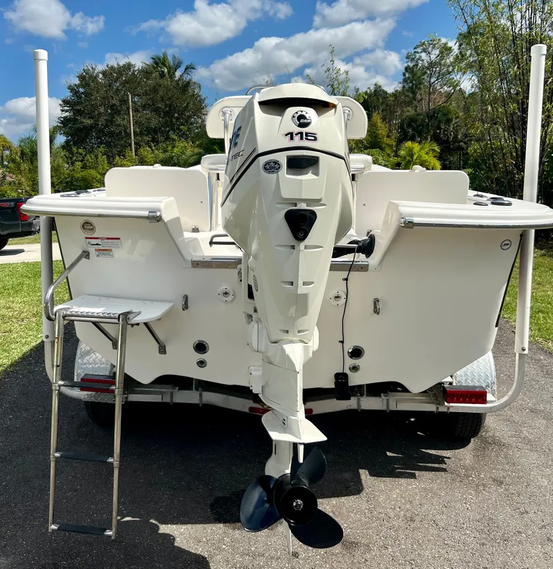Slide: The Image of 2010 Carolina Skiff 198 DLV Elite boat with 115 HP outboard motor, rear view. - 19
