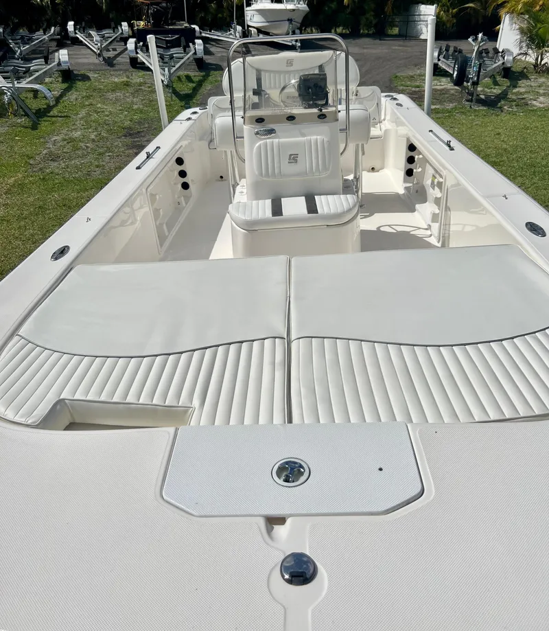 Slide: The Image of 2010 Carolina Skiff 198 DLV Elite boat interior with white seating and console. - 20