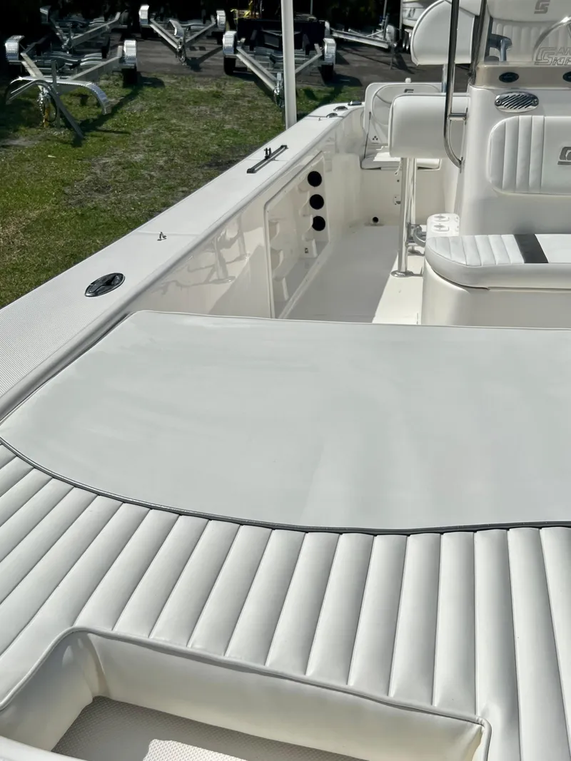Slide: The Image of 2010 Carolina Skiff 198 DLV Elite boat interior with white cushioned seating. - 22
