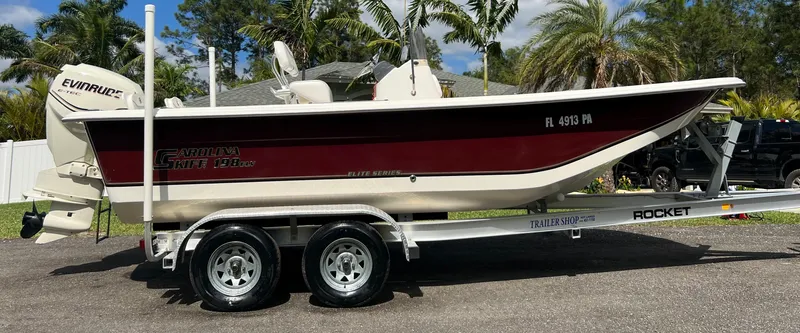 Slide: The Image of 2010 Carolina Skiff 198 DLV Elite boat on a Rocket trailer with Evinrude outboard motor. - 3