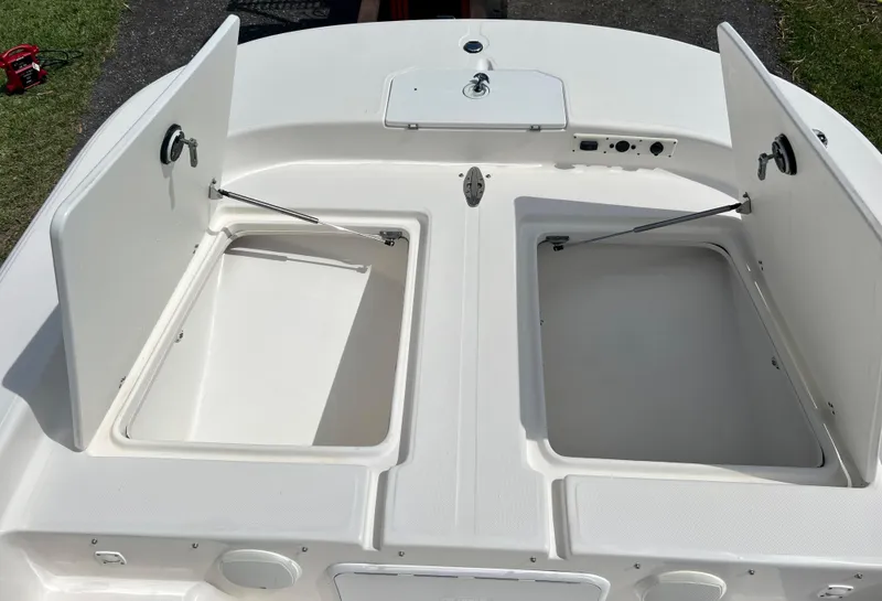 Slide: The Image of 2010 Carolina Skiff 198 DLV Elite boat storage compartments open. - 8