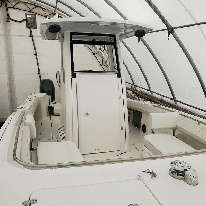 Slide: The Image of 2023 World Cat 260CC-X center console boat in a storage tent. - 3