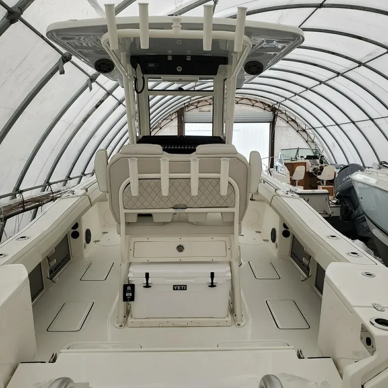 Slide: The Image of 2023 World Cat 260CC-X center console boat in covered storage. - 4