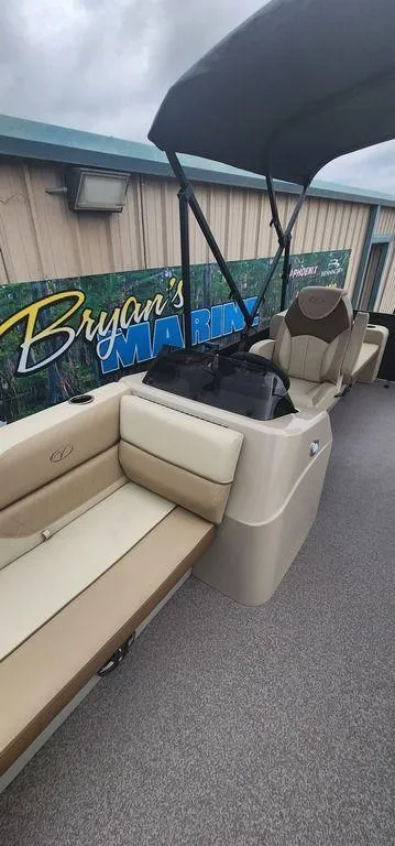 Slide: The Image of 2023 Veranda VISTA20RC Bi-Toon boat interior with beige seating and canopy. - 13