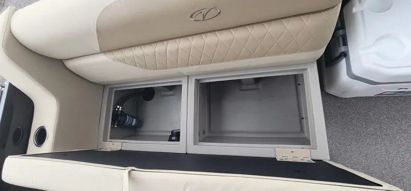 Slide: The Image of 2023 Veranda VISTA20RC Bi-Toon boat storage compartments with beige cushioned seating. - 20
