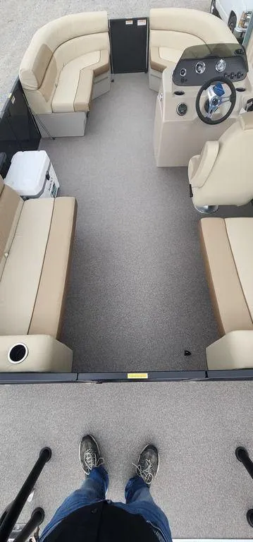 Slide: The Image of 2023 Veranda VISTA20RC Bi-Toon interior with beige seating and steering console. - 25