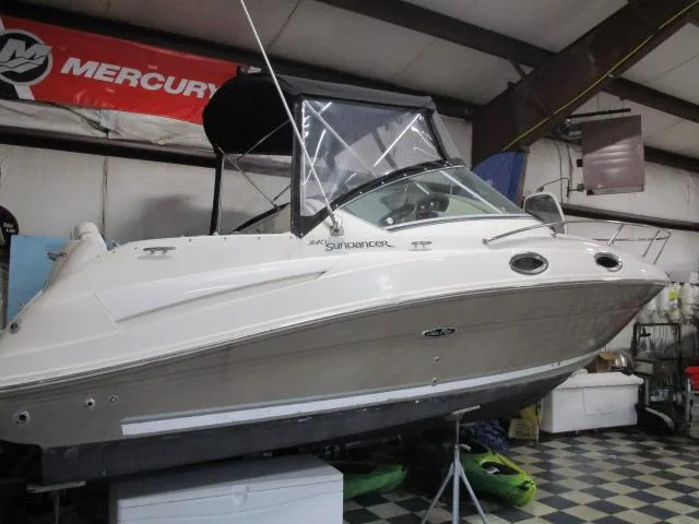 Slide: The Image of Rear view of a 2006 Sea Ray 240 Sundancer boat with a black cover. - 3