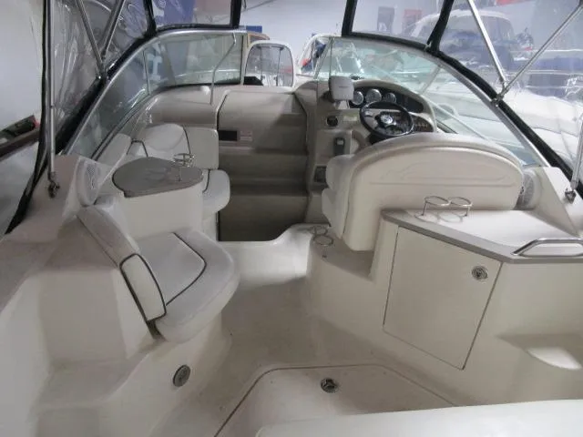 Slide: The Image of 2006 Sea Ray 240 Sundancer boat cockpit with steering wheel and seating. - 4