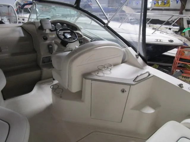 Slide: The Image of 2006 Sea Ray 240 Sundancer boat interior with white seating and cup holders. - 5