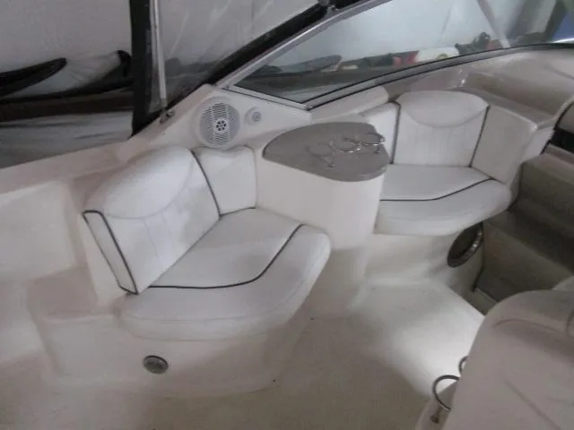 Slide: The Image of 2006 Sea Ray 240 Sundancer boat interior with white seating and cup holders. - 6