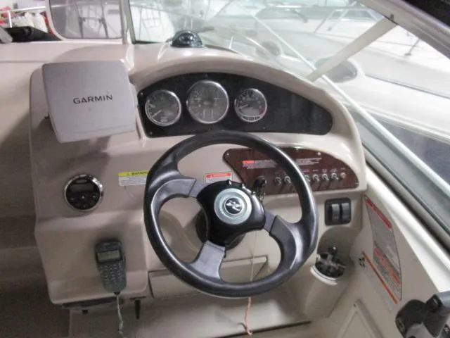 Slide: The Image of 2006 Sea Ray 240 Sundancer cabin interior with kitchenette and seating area. - 8